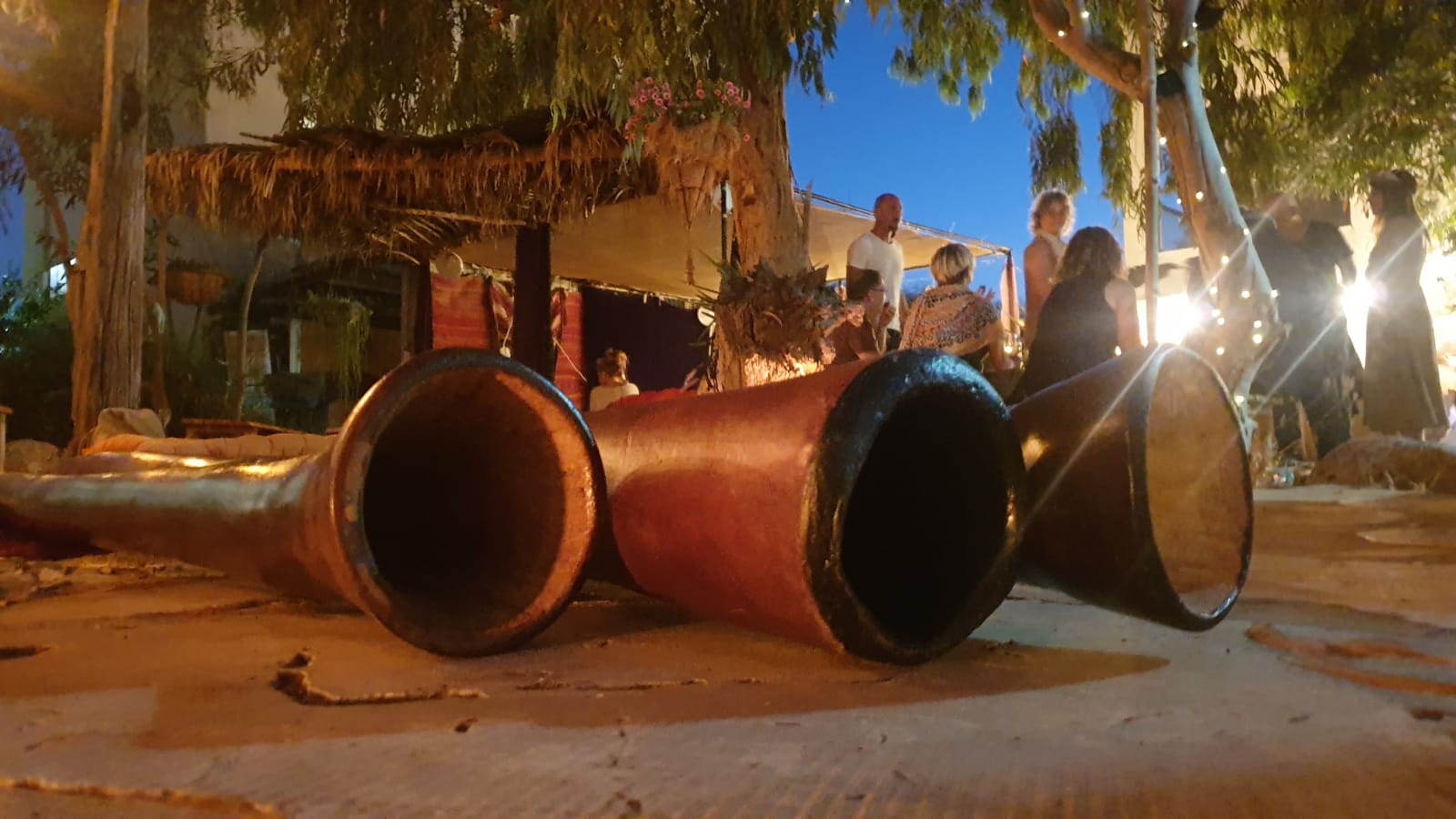 Didgeridoos at a workshop, gathered group beyond